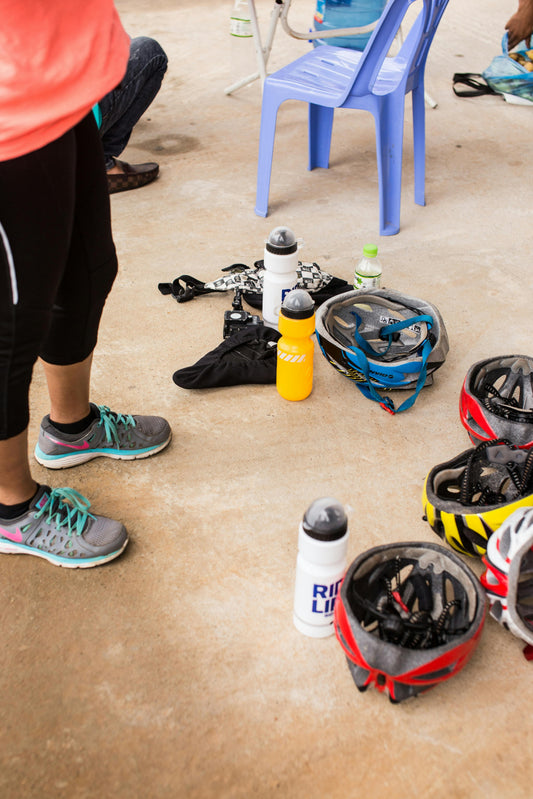 Cycling gear with helmets and water bottles — essential accessories flat lay