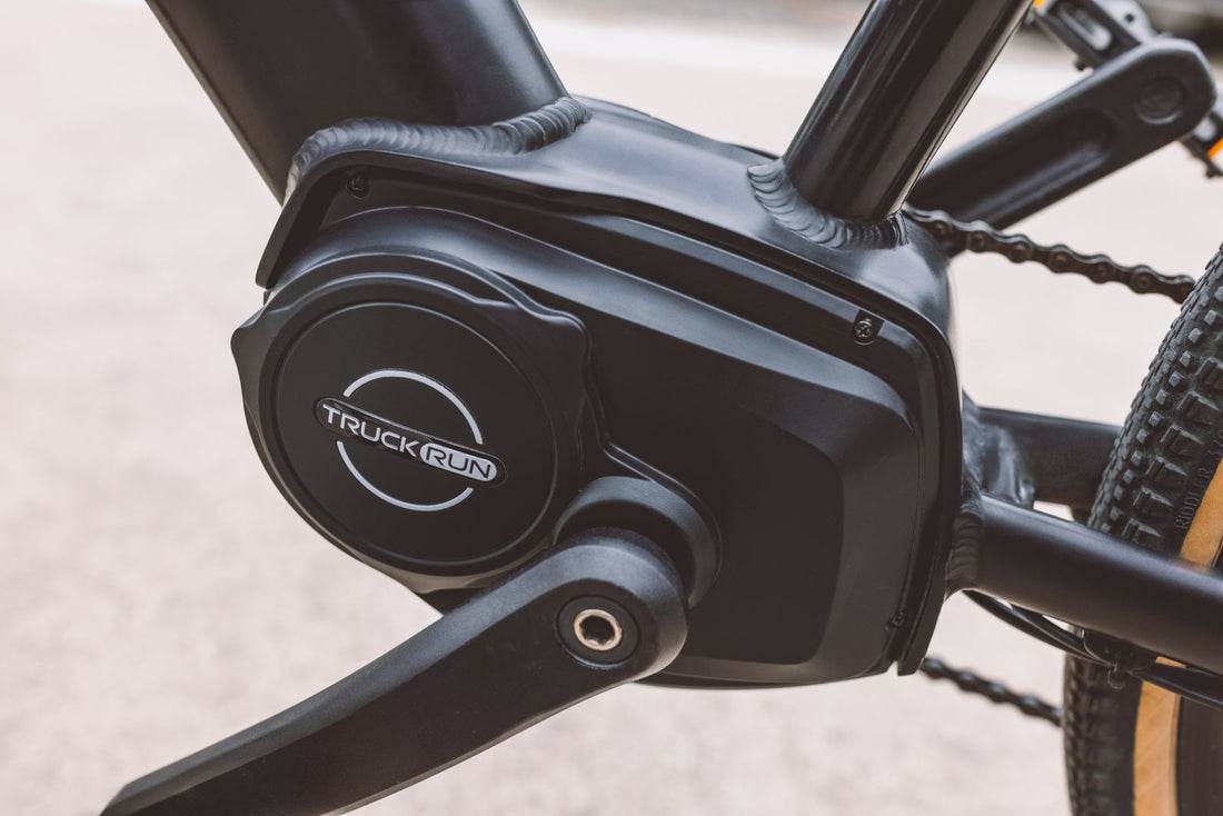 Close-up of the motor and pedal crank area on a black electric bike